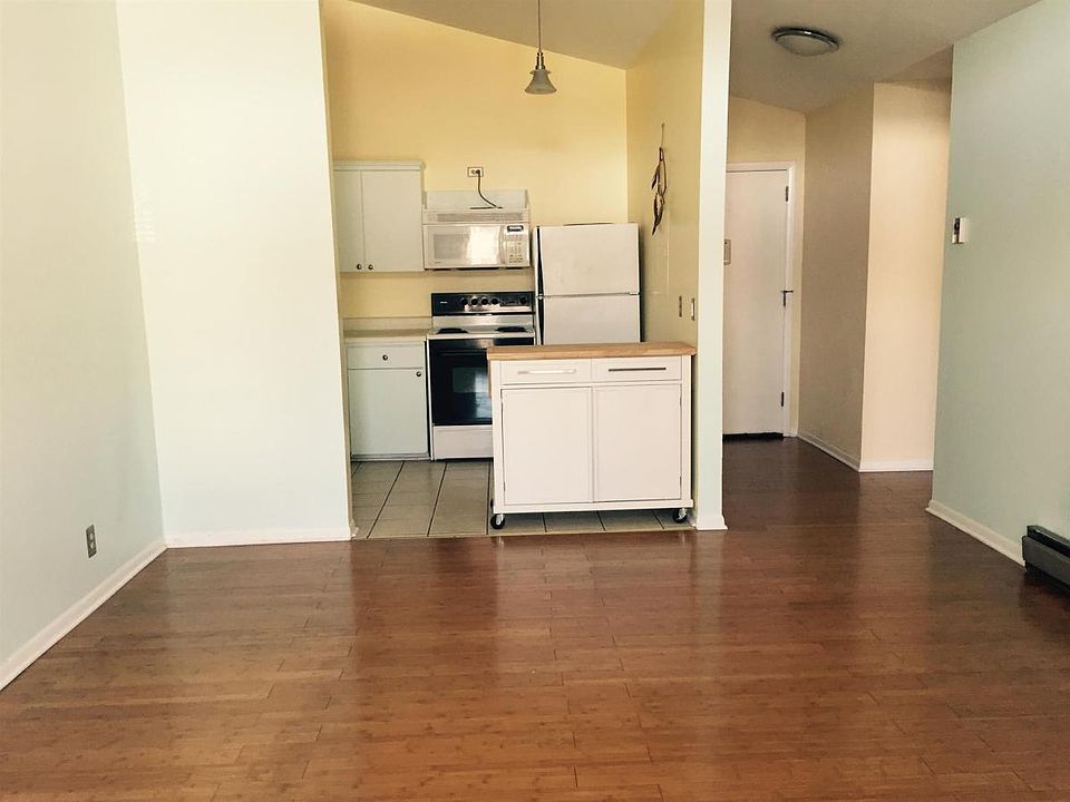 The spacious living room is open and bright. It feels like w