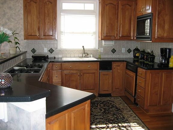 kitchen with hard surface counter top with maple cabinets