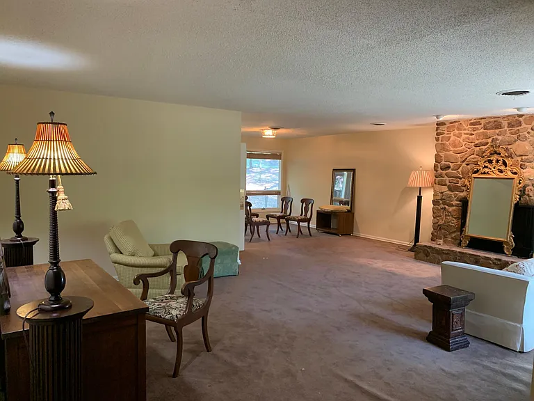 Living Room and Dining Area. Note: carpeting was recently replaced with waterproof laminate flooring. Updated photos to follow.