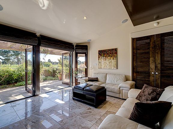 Two sets of double french doors open the main living room area to the stunning backyard view and patio