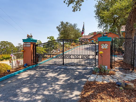 Gated entrance and fenced gardens that attract a variety of birds at the feeders and bird baths. Single level 2800 sq ft upscale executive style home.