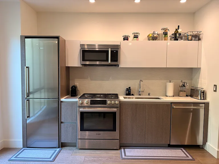 Kitchen area with Bosch Refrigerator/ Freezer, Microwave, Oven, Dishwasher and plenty of storage. 
Comes completely equipped for all your cooking and entertaining needs.