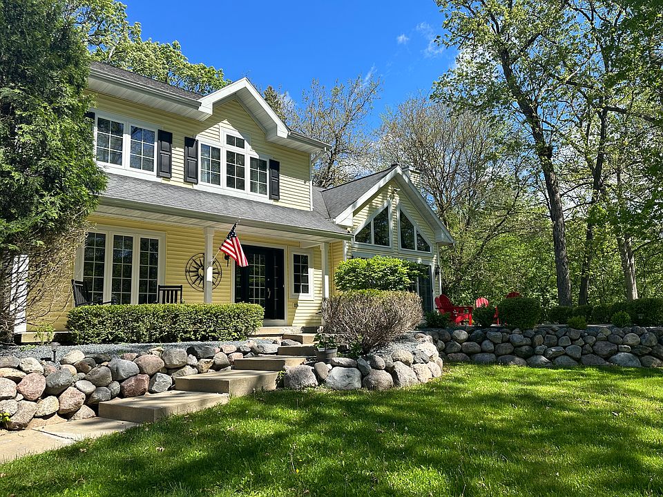 Covered porch with rocking chairs, elevated patio with lake view