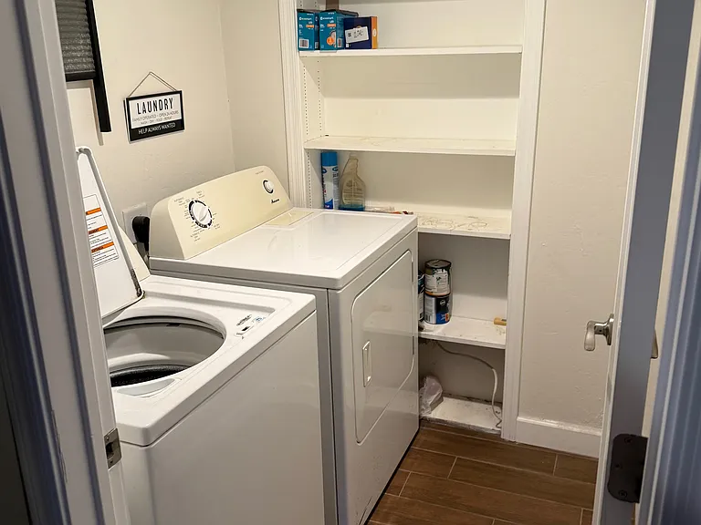 laundry room with washer, dryer, and built-in shelving