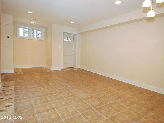 Front entrance to open space. Create a living room, dining room, office nook next to the windows.