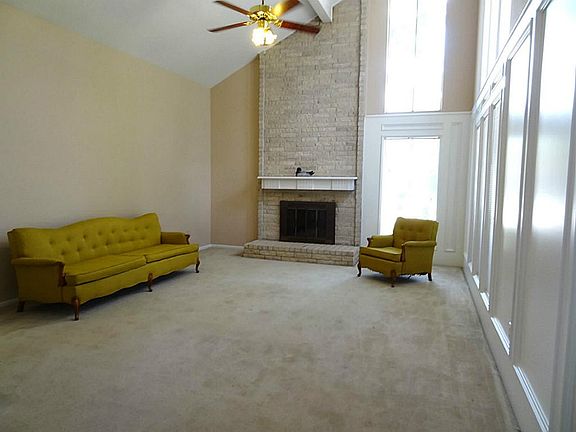 DEN HAS A FIREPLACE REACHES THE HIGH CEILING IN THE DEN.