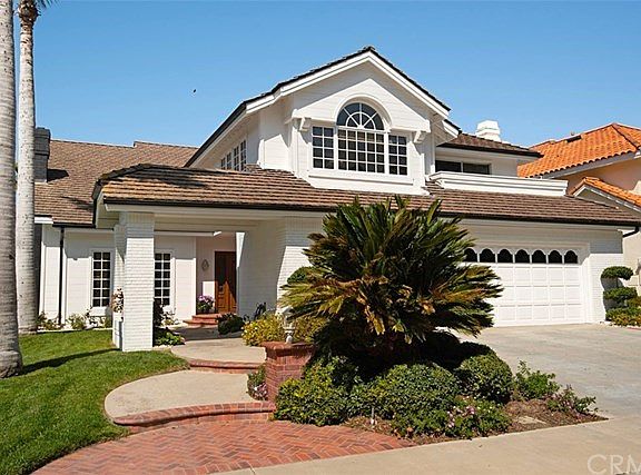 The brick-lined walk-way steps up to the impressive entrance.
