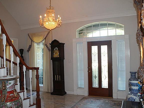 Two story foyer with marble flooring.  Chandelier reserved
