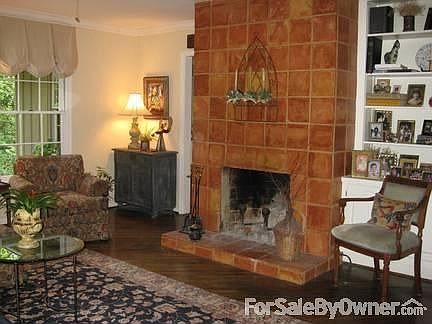 Another view of the den with Mexican tile fireplace and built-in bookshelves.