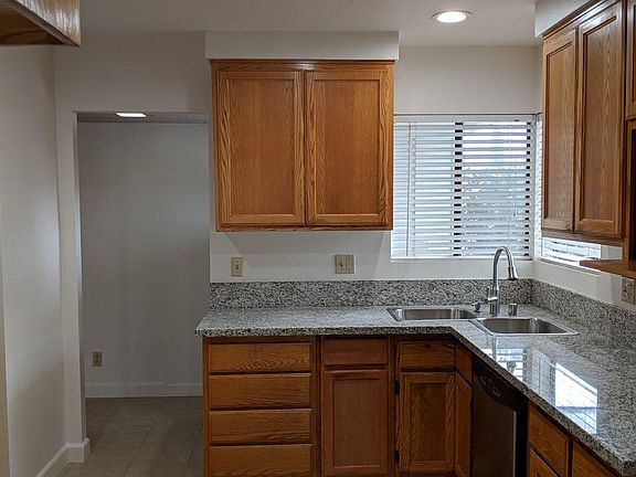 Large kitchen we with granite countertop and lots of cabinets