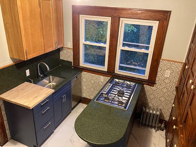 Updated kitchen with Bosch appliances and a five burner stove top. Granite countertops