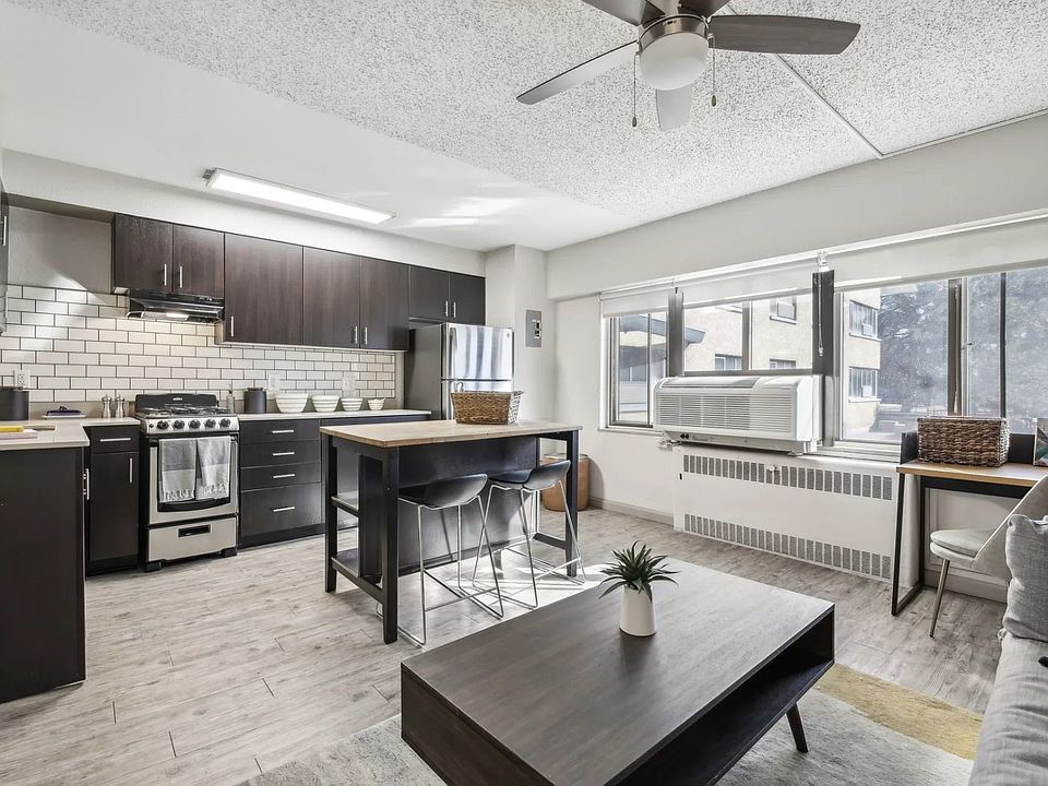 A view of the city can be seen from the large windows that allow light to seep into the living room and kitchen