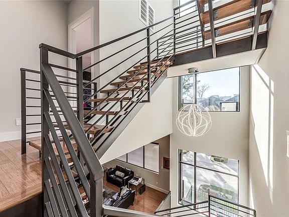 A detail shot of the staircase to highlight the openness of this floor plan. This design also allows for daylight to fill the shared spaces throughout the home.