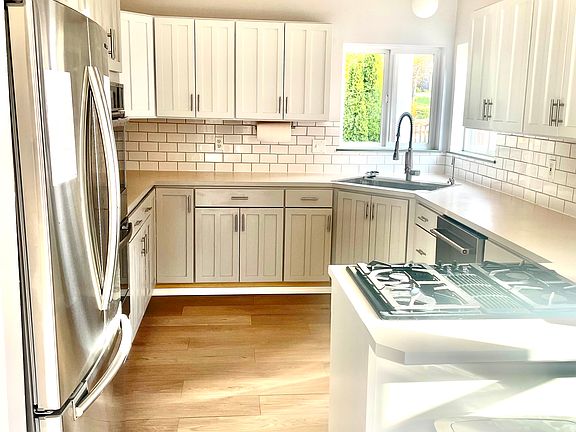 Spacious kitchen with ample counterspace, gas range, double ovens, and new dishwasher