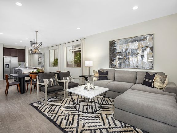 The great room flows into the kitchen and dining area in this open concept plan.
