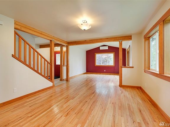 Open concept living & dining areas with wood floors.  