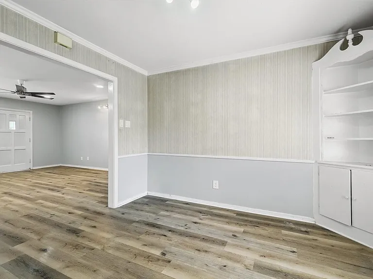 This charming dining room has beautiful architectural detail with the corner built-in cabinets and view of the back yard
