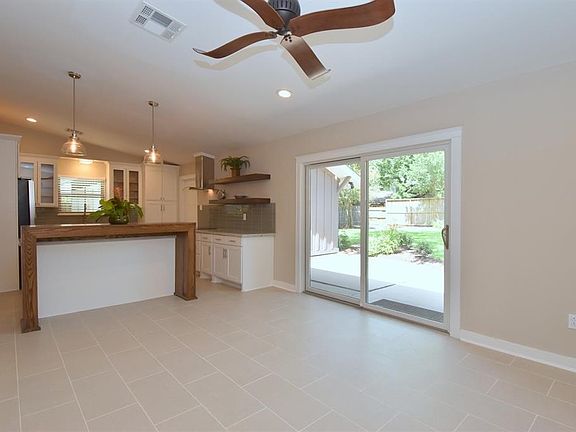Another view of the den looking through to the kitchen after the remodel and out to the back yard prior to Harvey.