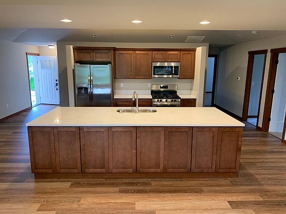 Modern appliances and quartz countertops.