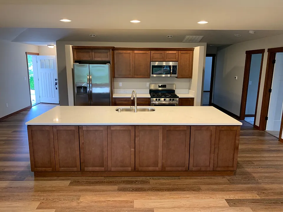 Modern appliances and quartz countertops.