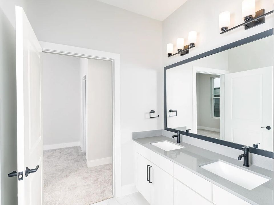 Designer bathrooms featuring quartz countertops and dual sinks for ultimate comfort and style.