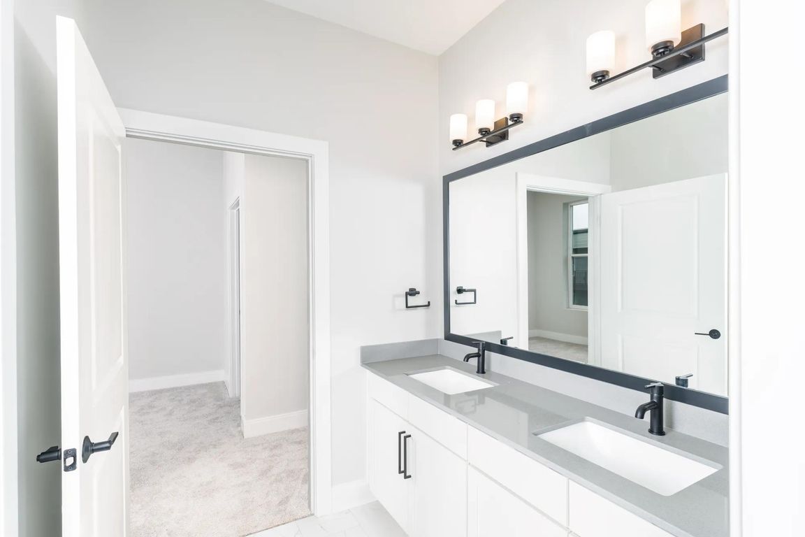 Designer bathrooms featuring quartz countertops and dual sinks for ultimate comfort and style.