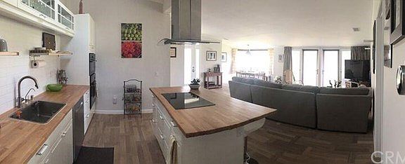 Gourmet kitchen with an induction stove top on the kitchen island.  Top of the line appliances.