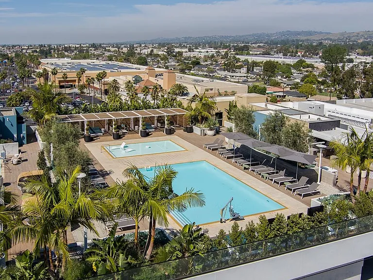 Building A rooftop pool and sundeck with lounge seating and cabanas