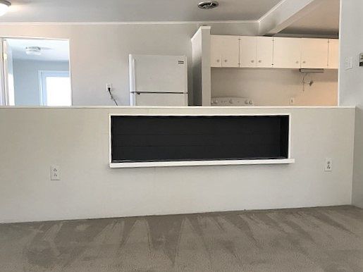 1/2 wall between kitchen and living room with built-in bookcase
