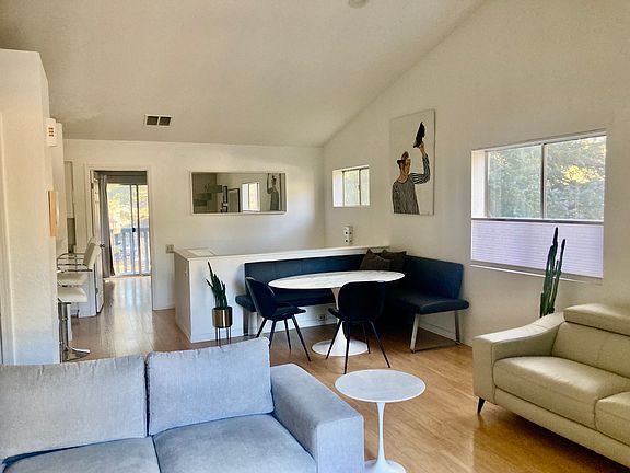 Large open-floor plan living and dining area with vaulted ceilings