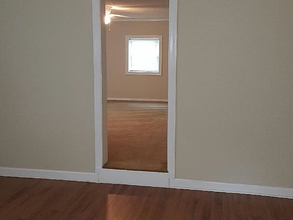 View of Living and dining Room w/ Bedroom in Background