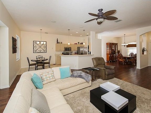 A nice flow from room to room, warm engineered wood floors, neutral colors and full-pocket sliders.