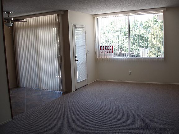 LIVING ROOM AND DINING AREA WITH ADJACENT BALCONY