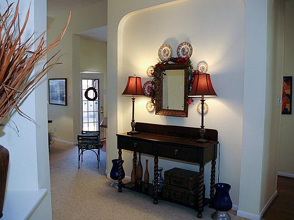 Art niches and accent walls off of the entry can house your favorite decor.