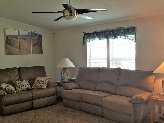 living room with remote ceiling fan