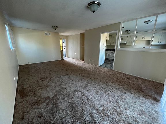 Looking back toward front door from sliding door. Kitchen on the right.