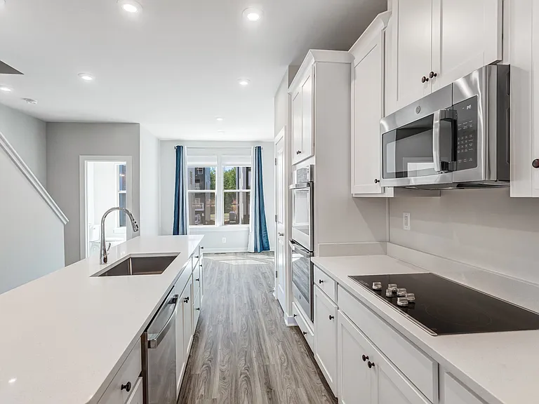Modern open kitchen with quartz countertops, stainless steel appliances, and plenty of space for cooking and entertaining.