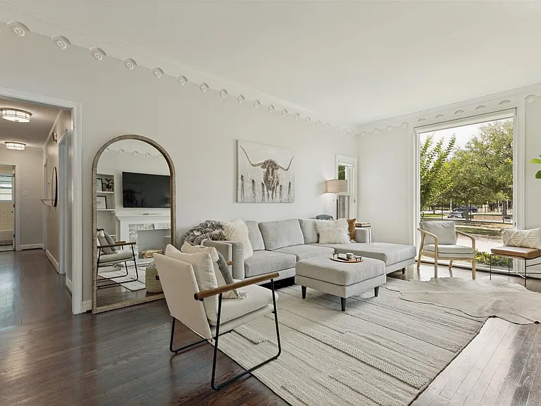 Living room has lots of windows for natural light.