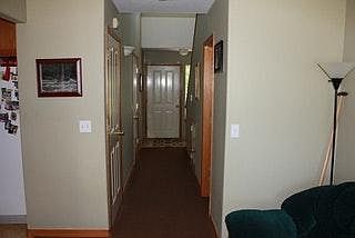 Bathroom and garage entrance in hall.