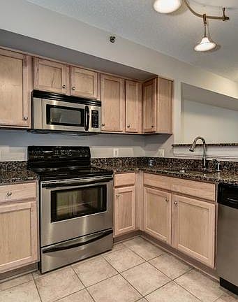 MAPLE WOOD CABINETRY and CERAMIC TILE FLOORING!
