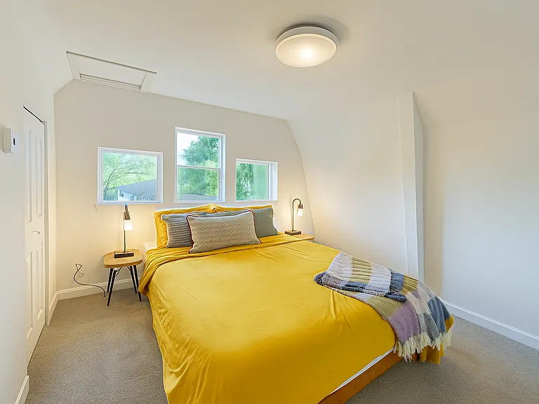 Bright and inviting, this bedroom features a plush queen mattress _perfect for a restful night