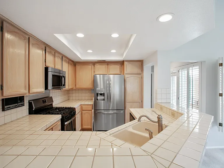 Kitchen with new refrigerator, stove/oven, microwave and dishwasher