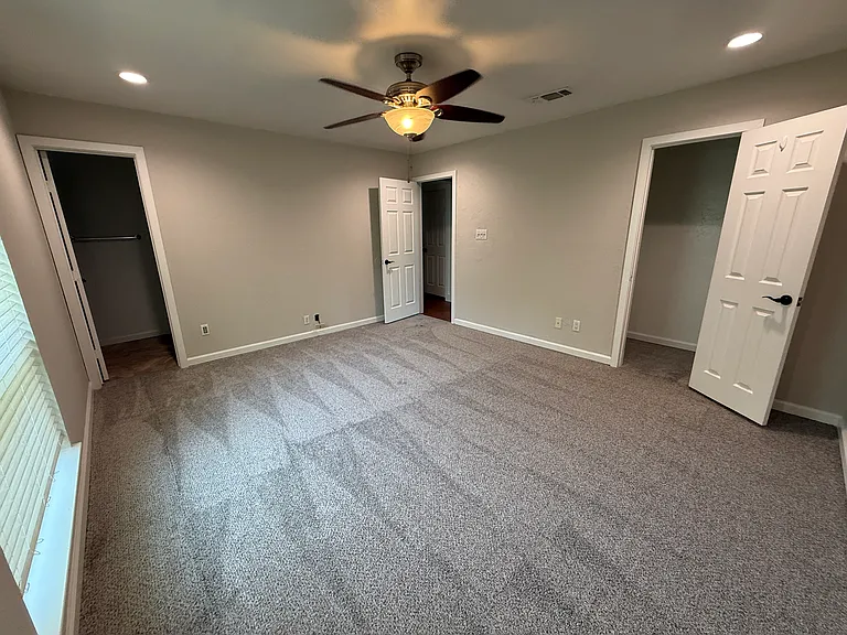 Primary Bedroom with a walk-in closet and en suite Bathroom