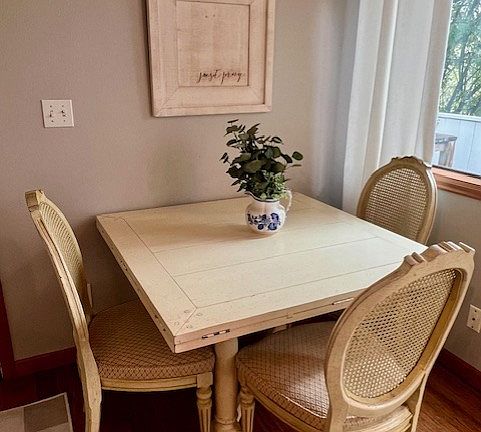 Dining area with table. Table expands and has extension leaves: the 4th chair is located nearby.