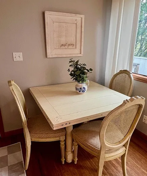 Dining area with table. Table expands and has extension leaves: the 4th chair is located nearby.
