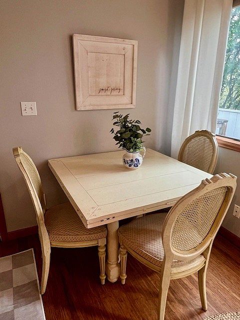 Dining area with table. Table expands and has extension leaves: the 4th chair is located nearby.