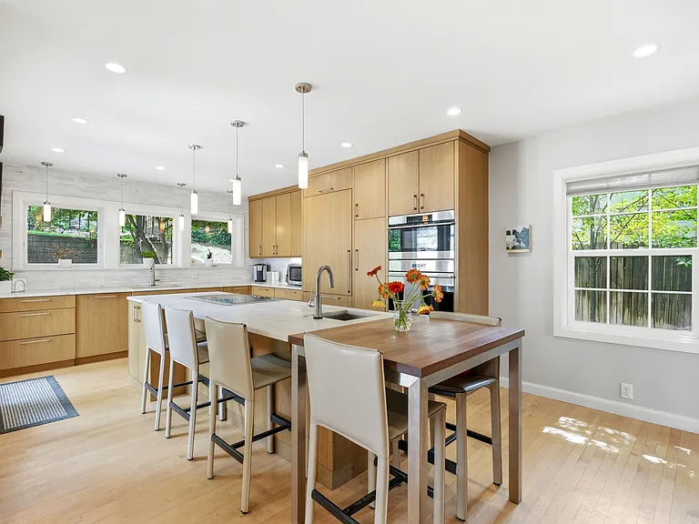 Spacious kitchen with lots of windows and patio entrance as well as adjacent dining room.