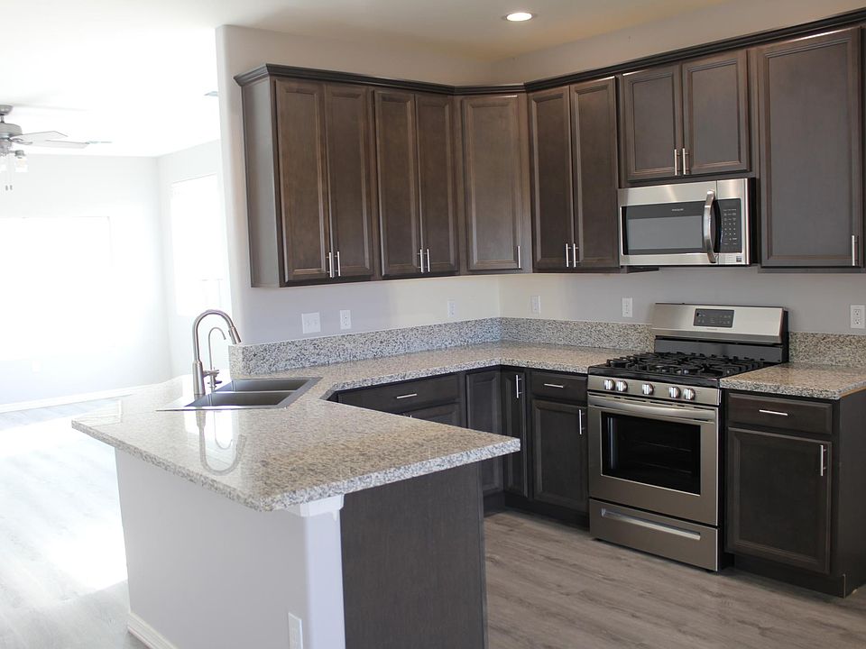beautiful granite counters with all new appliances and tall cabinets