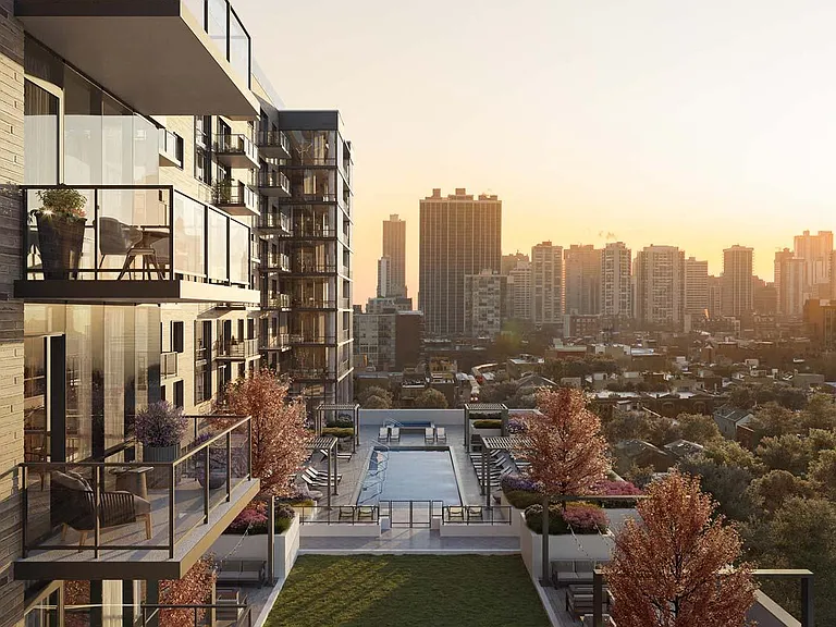 Relax on the balcony with beautiful views of the glass balconies, the pool, and the lush grass area, creating a peaceful and inviting atmosphere.