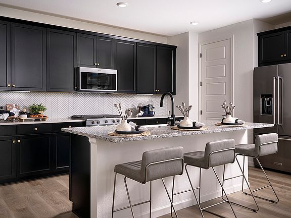 Example of Kitchen with Black Cabinetry, Granite Countertops and Decorative Herringbone Backsplash